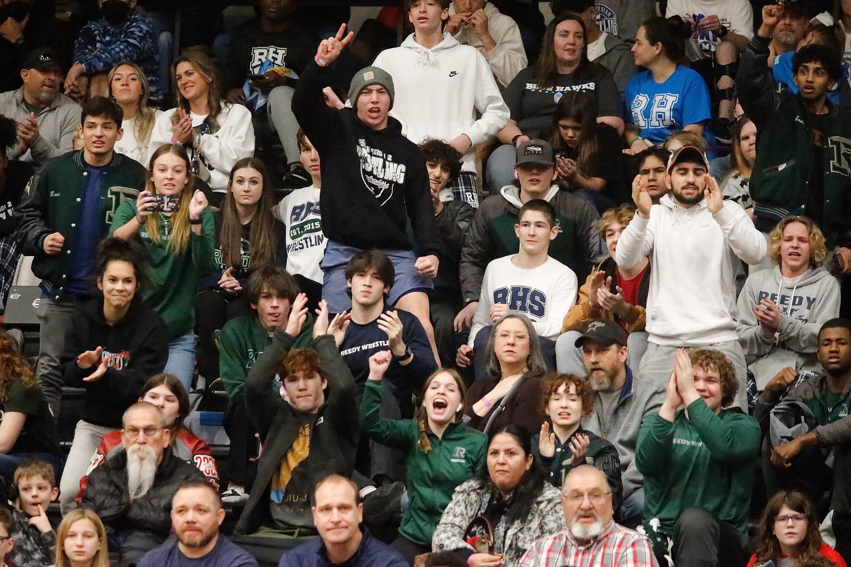 Reedy High School students cheer as Max Villasana wins the 126 divison match of the Class 5A...