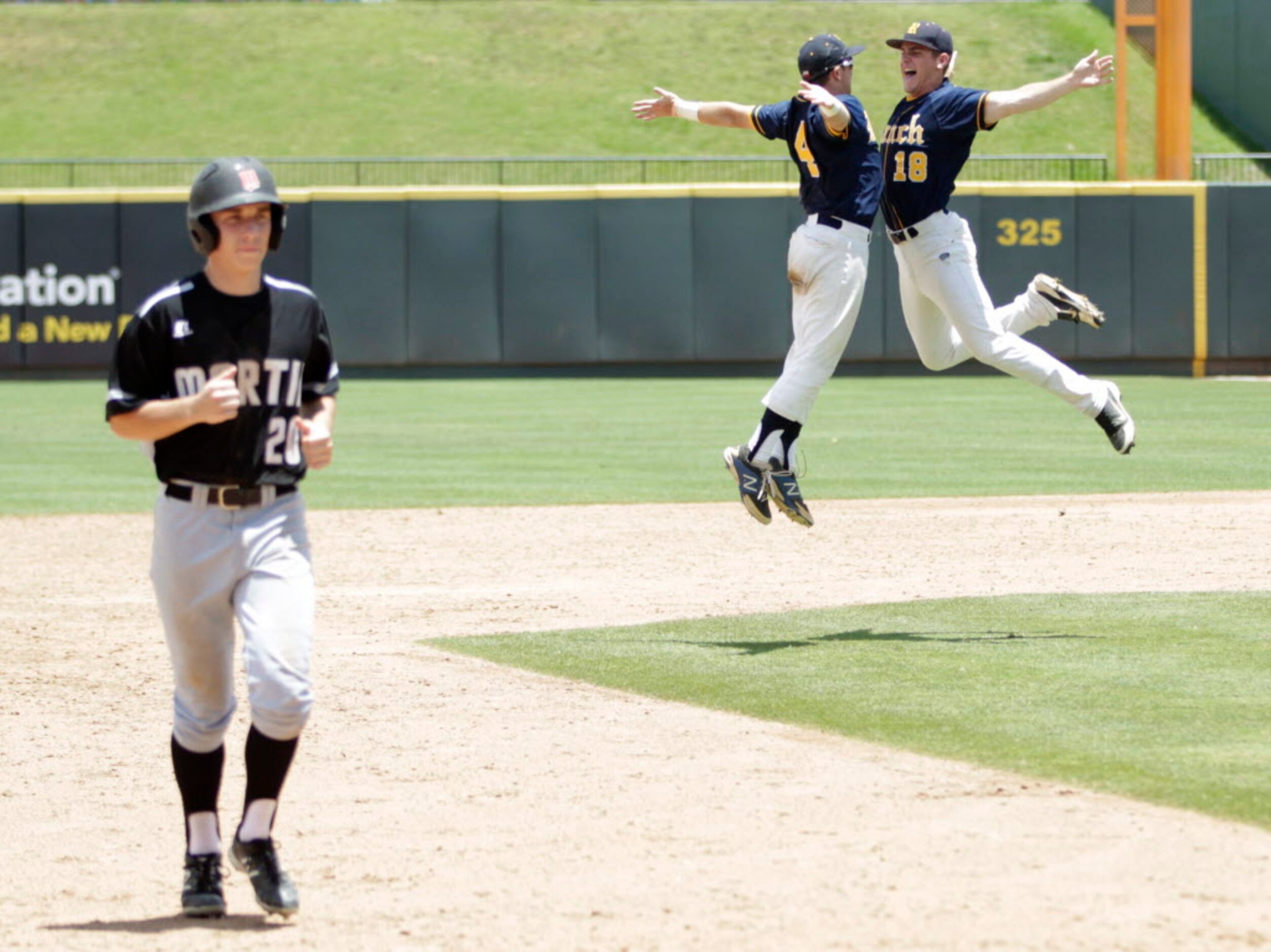 Cypress Ranch's Hayden Evans (4) and Collin Rock (18) celebrate as Martin's Stuart Stone...