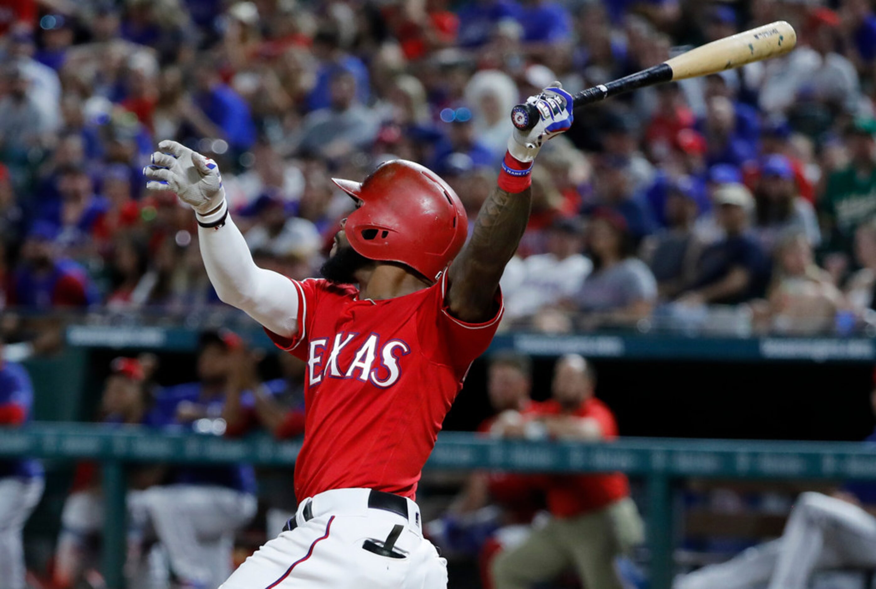 Texas Rangers' Delino DeShields follows through on a sacrifice fly to right on a pitch from...