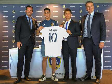 Forward Cristian PavÃ³n, second from left, of Argentina, holds up his new LA Galaxy jersey...