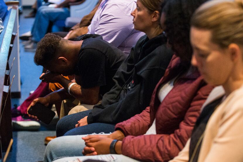 A young man wipes a tear as he prays during an interfaith "Justice for Jordan Edwards"...