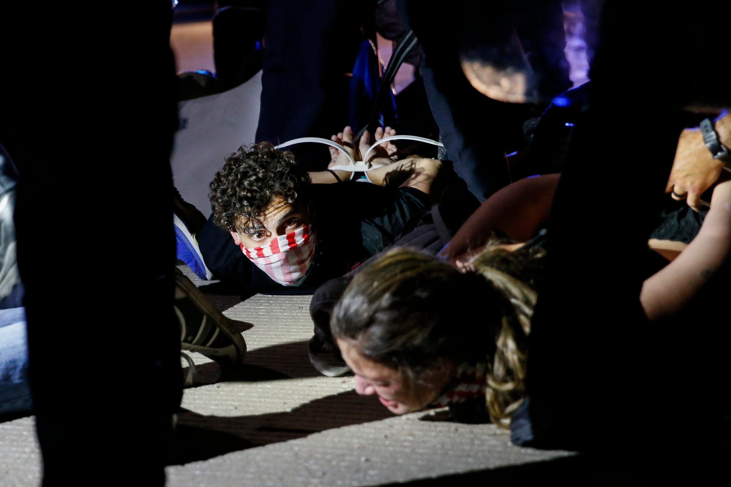 Police surround and detain hundreds of protesters who marched onto the Margaret Hunt Hill...