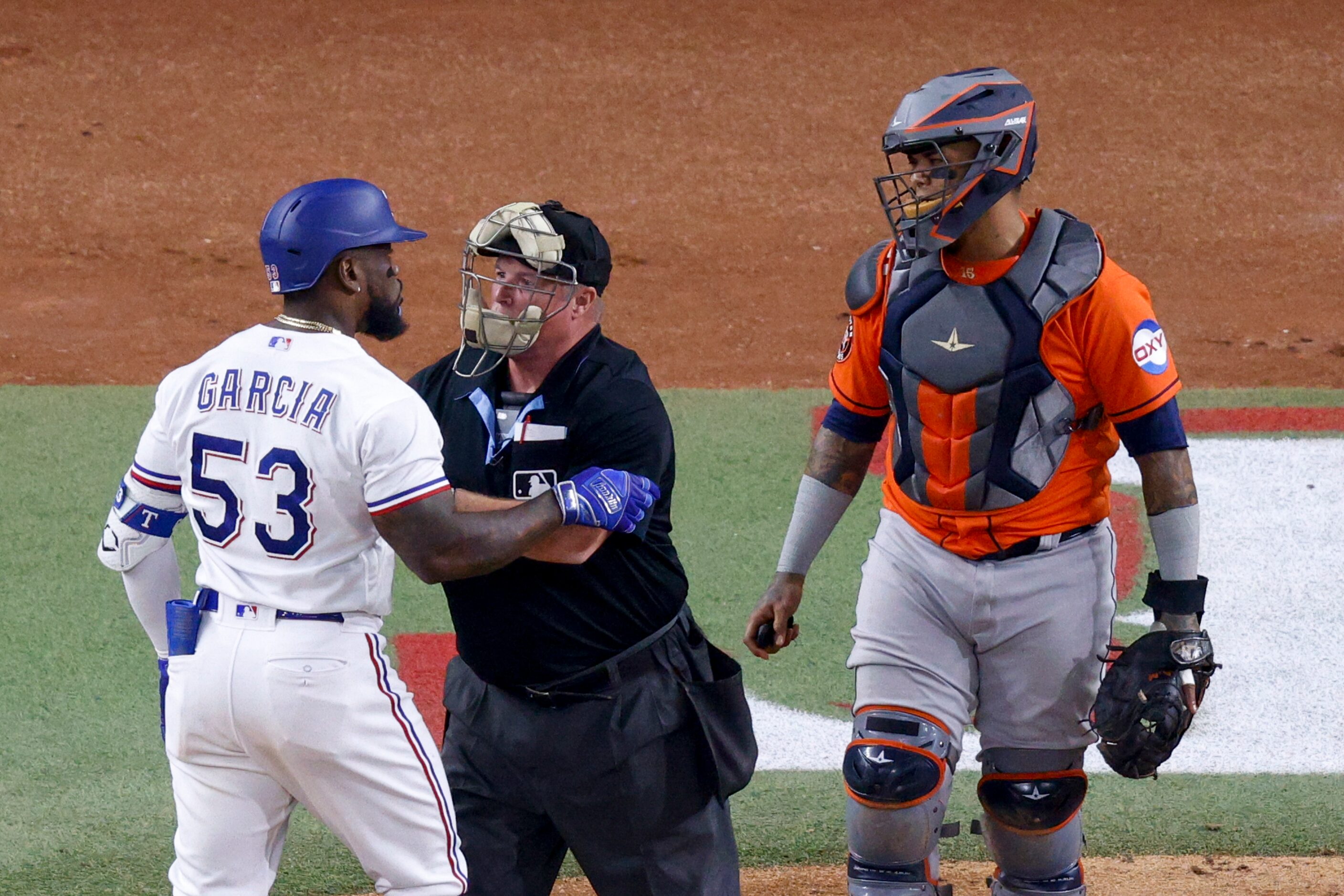 Texas Rangers right fielder Adolis Garcia (53) argues with Houston Astros catcher Martin...