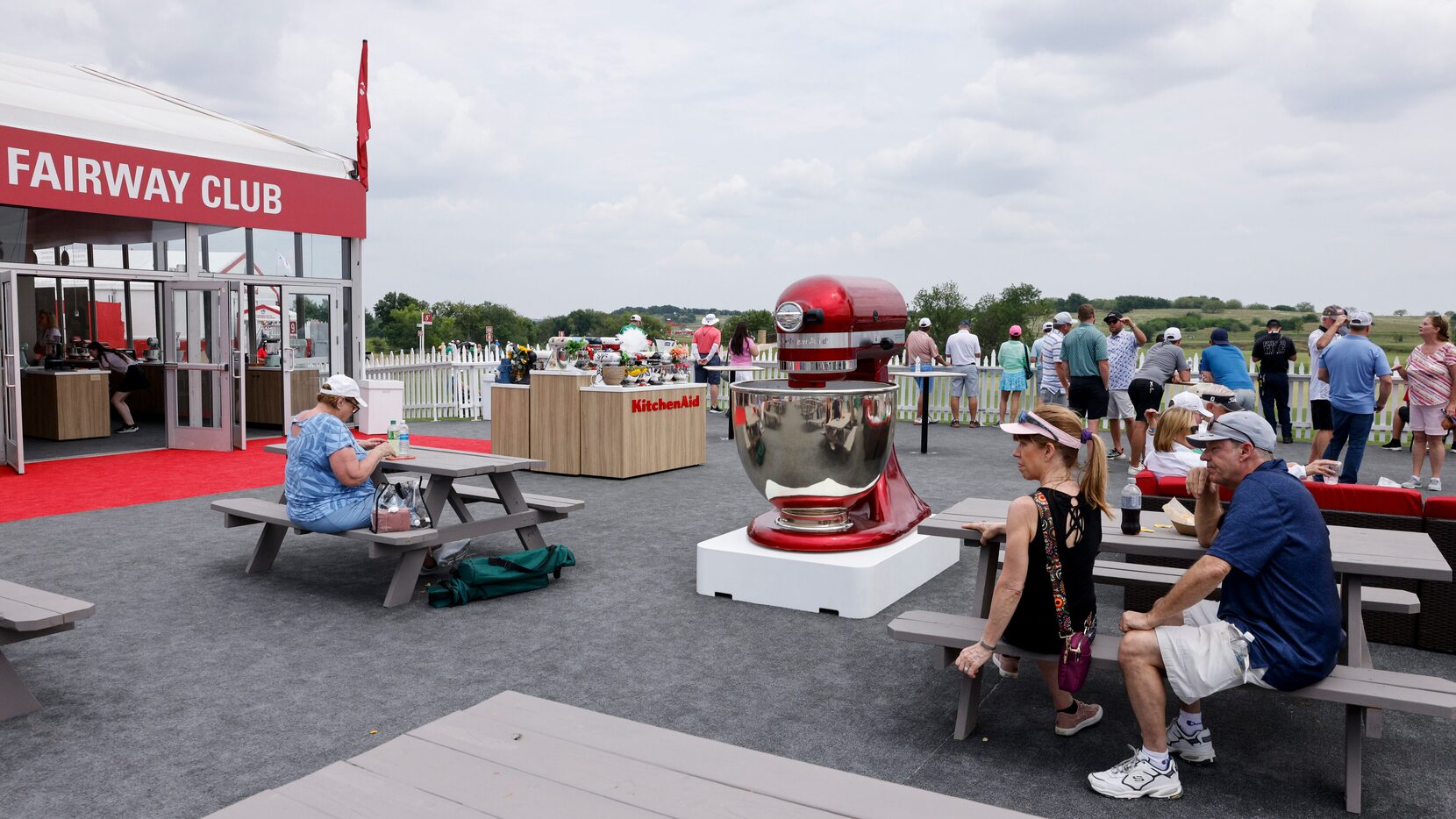 Golf fans sit and watch gameplay at the Fairway Club during the first round of the 83rd...