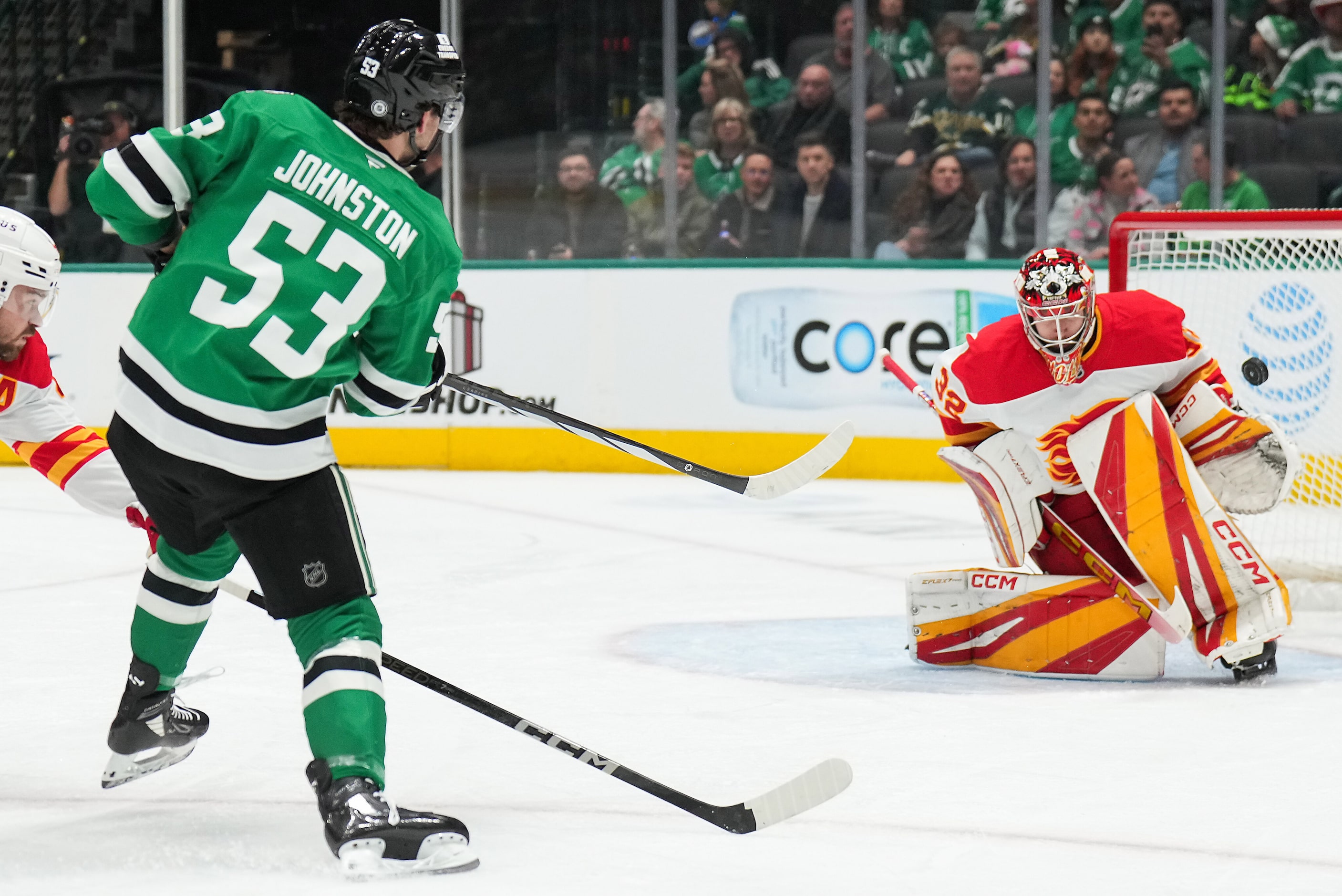 Dallas Stars center Wyatt Johnston (53) scores against Calgary Flames goaltender Dustin Wolf...