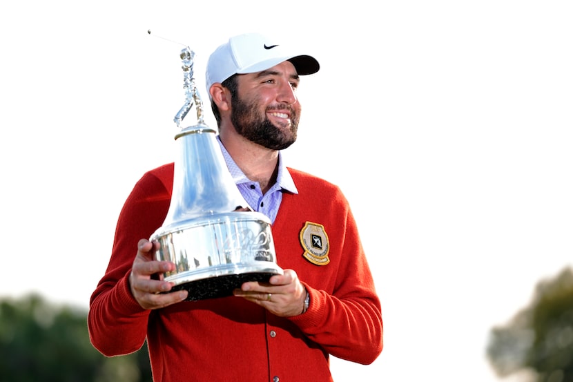 Scottie Scheffler holds the championship trophy after winning the Arnold Palmer Invitational...