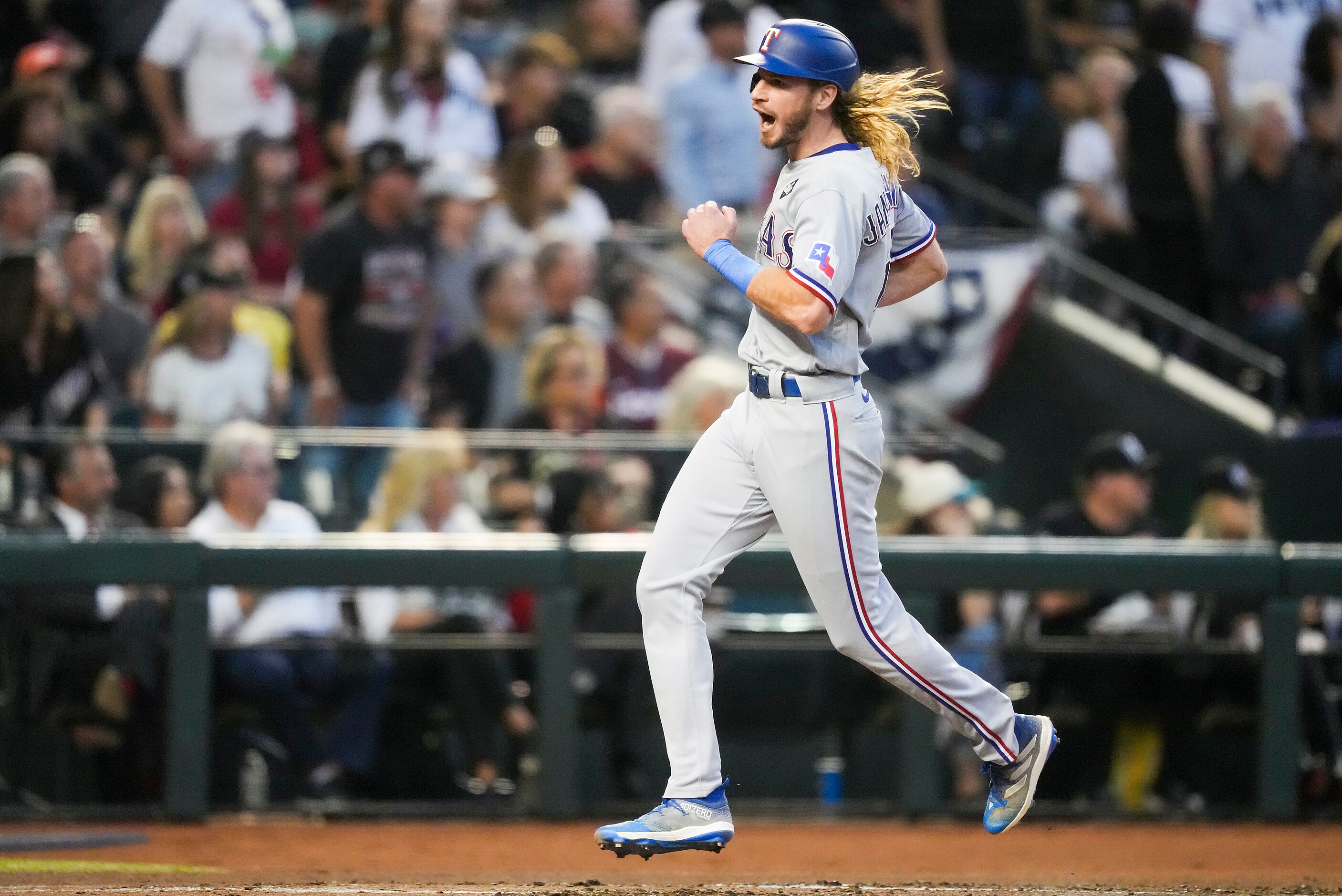 Texas Rangers right fielder Travis Jankowski scores on a two-run triple by Marcus Semien...