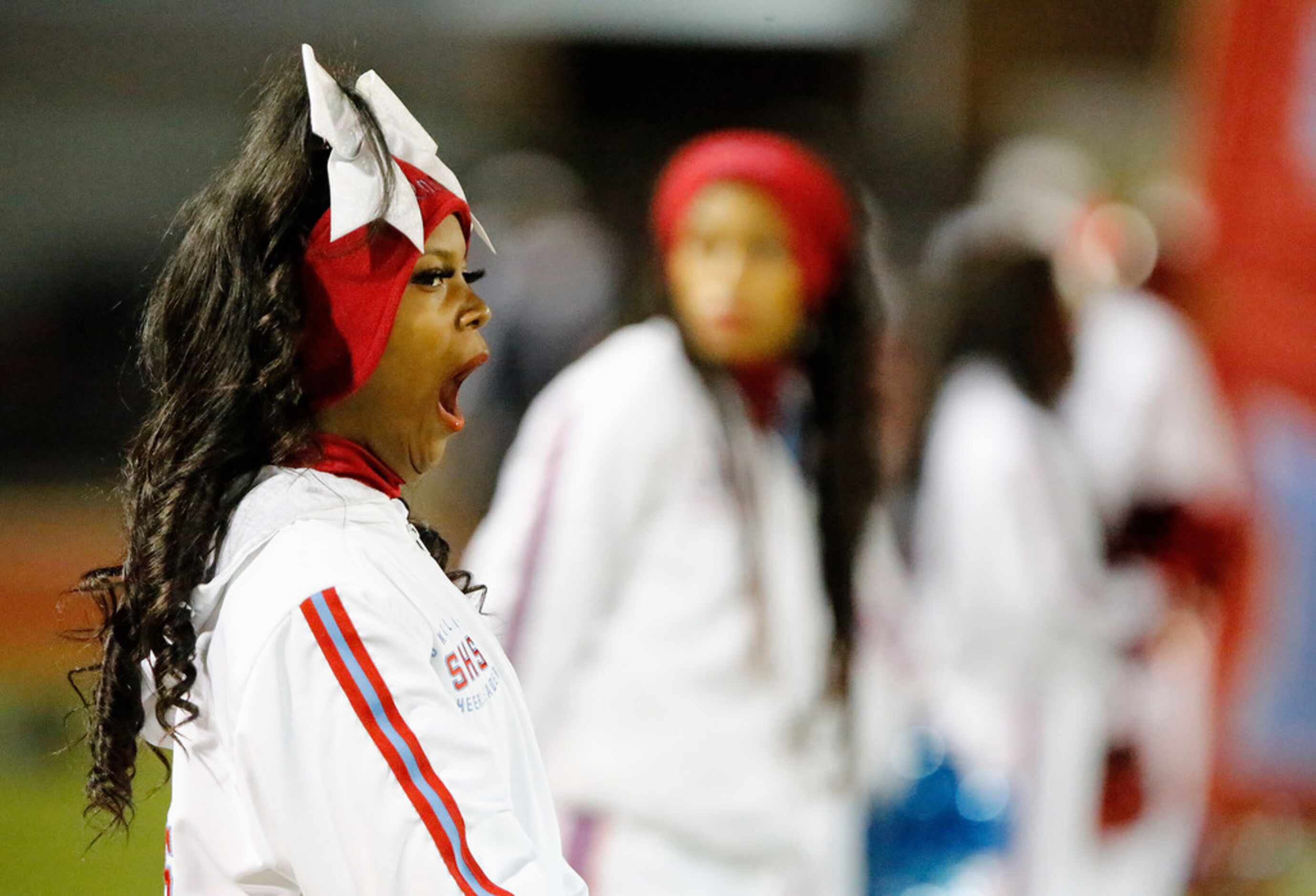 Skyline cheerleader Asiah Miller yawns while waiting for teams to take the field before...