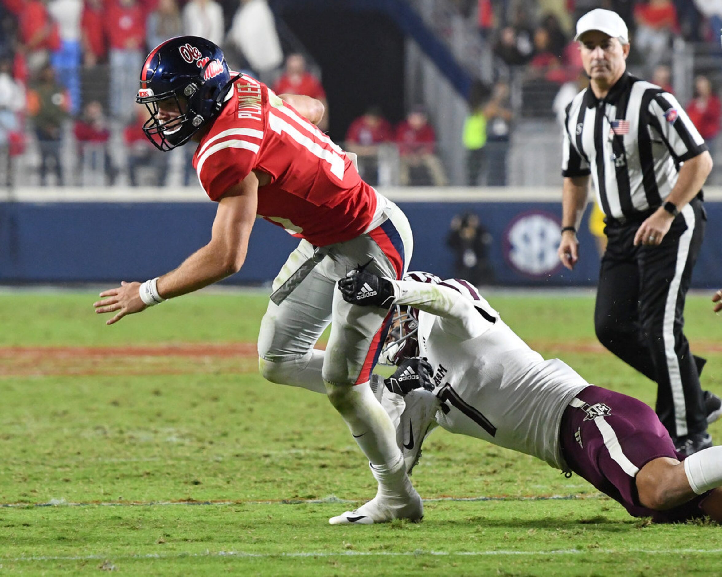 Texas A&M defensive back Devin Morris (7) tackles Mississippi quarterback John Rhys Plumlee...