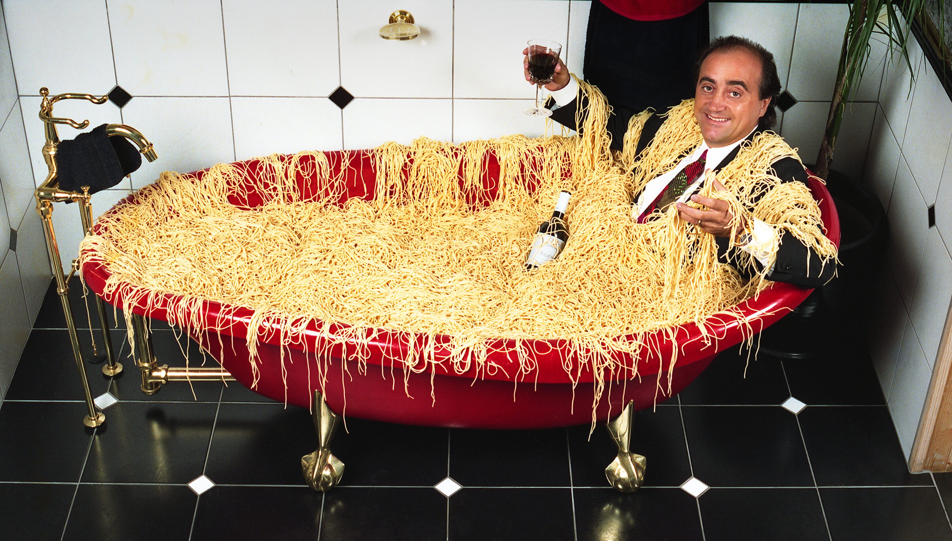  Alberto Lombardi, owner of Lombardi's restaurant, relaxes in a bathtub filled with his own...