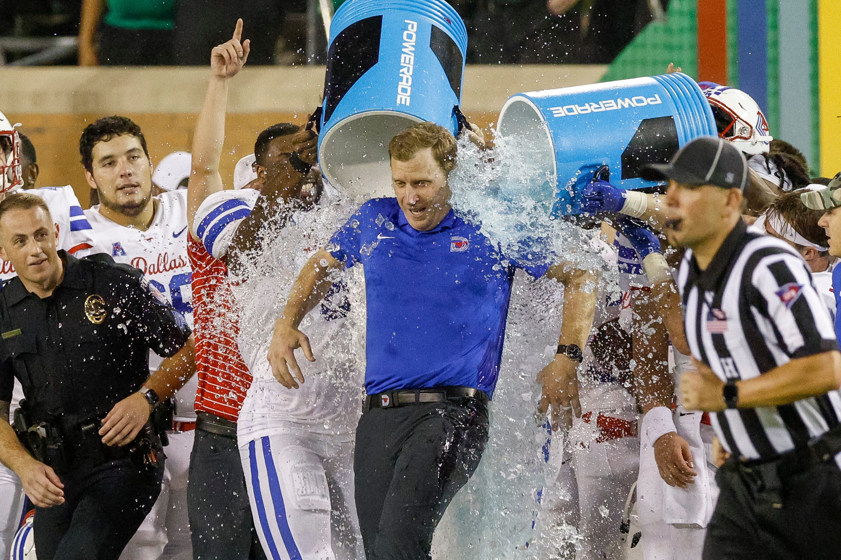 SMU head coach Rhett Lashlee is doused with ice water after a win against UNT at Apogee...