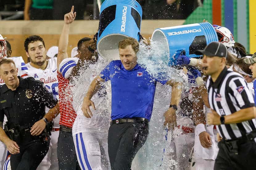 SMU head coach Rhett Lashlee is doused with ice water after a win against UNT at Apogee...