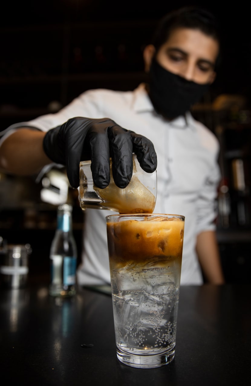 Manager Roberto Grimaldo pours an espresso shot into tonic water at Ascension Coffee.