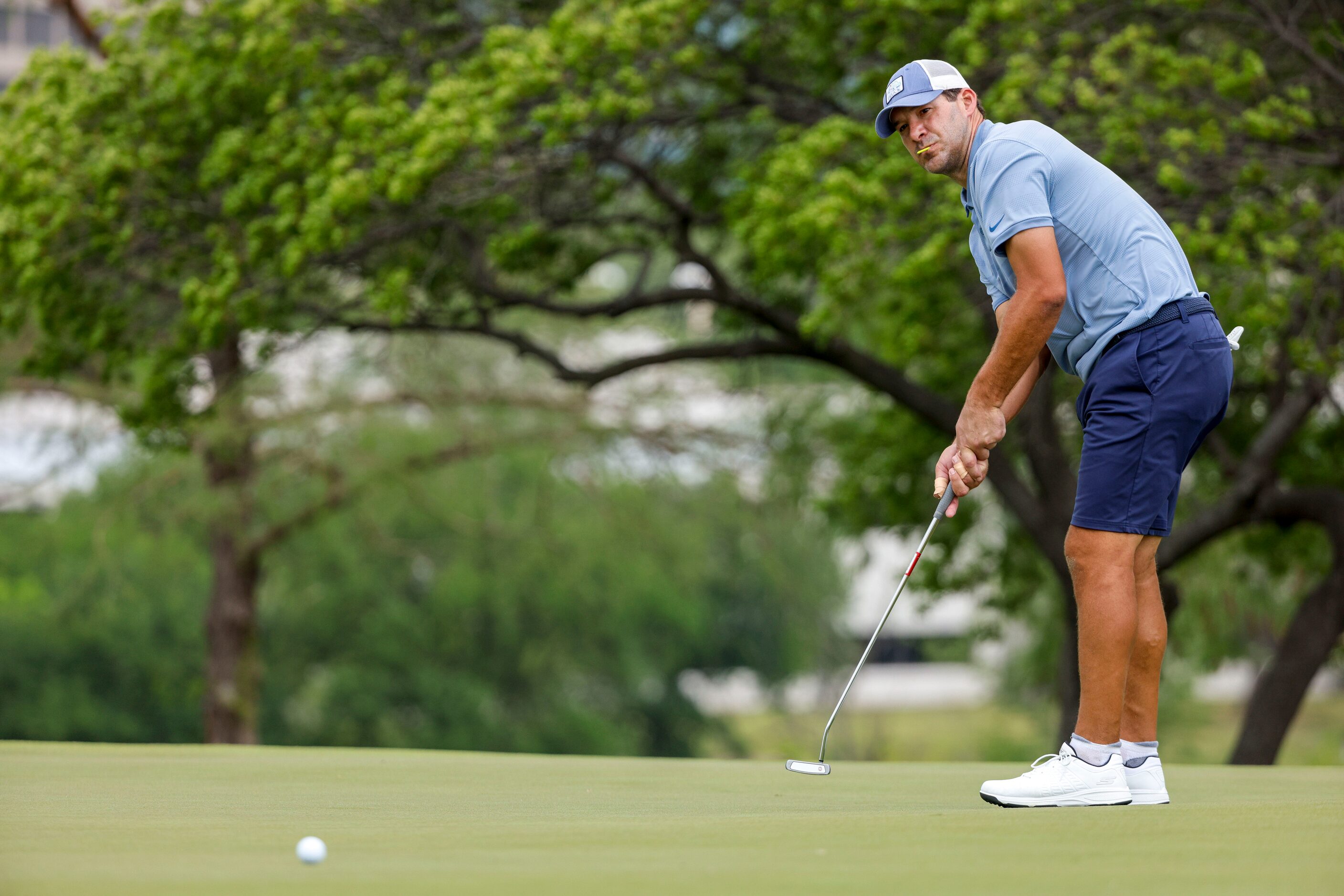 Former Dallas Cowboys quarterback Tony Romo watches his putt on the second green during the...