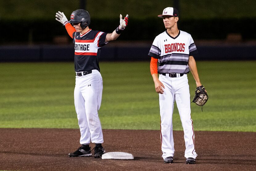 Colleyville Heritage catcher Nick Balsano celebrates after driving in a run with a double...