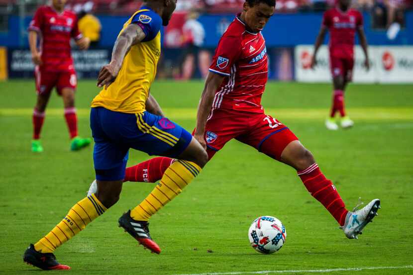 FC Dallas defender Reggie Cannon (22) kicks the ball ahead of Colorado Rapids defender...