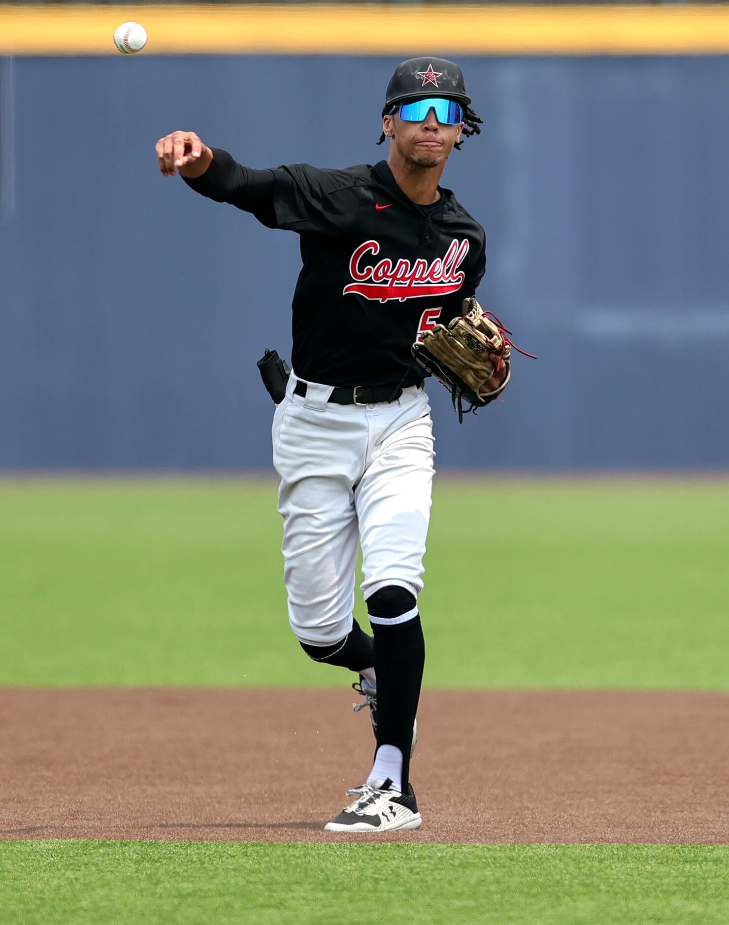 Coppell shortstop TJ Pompey makes a throw over to first base against Prosper during game 3...