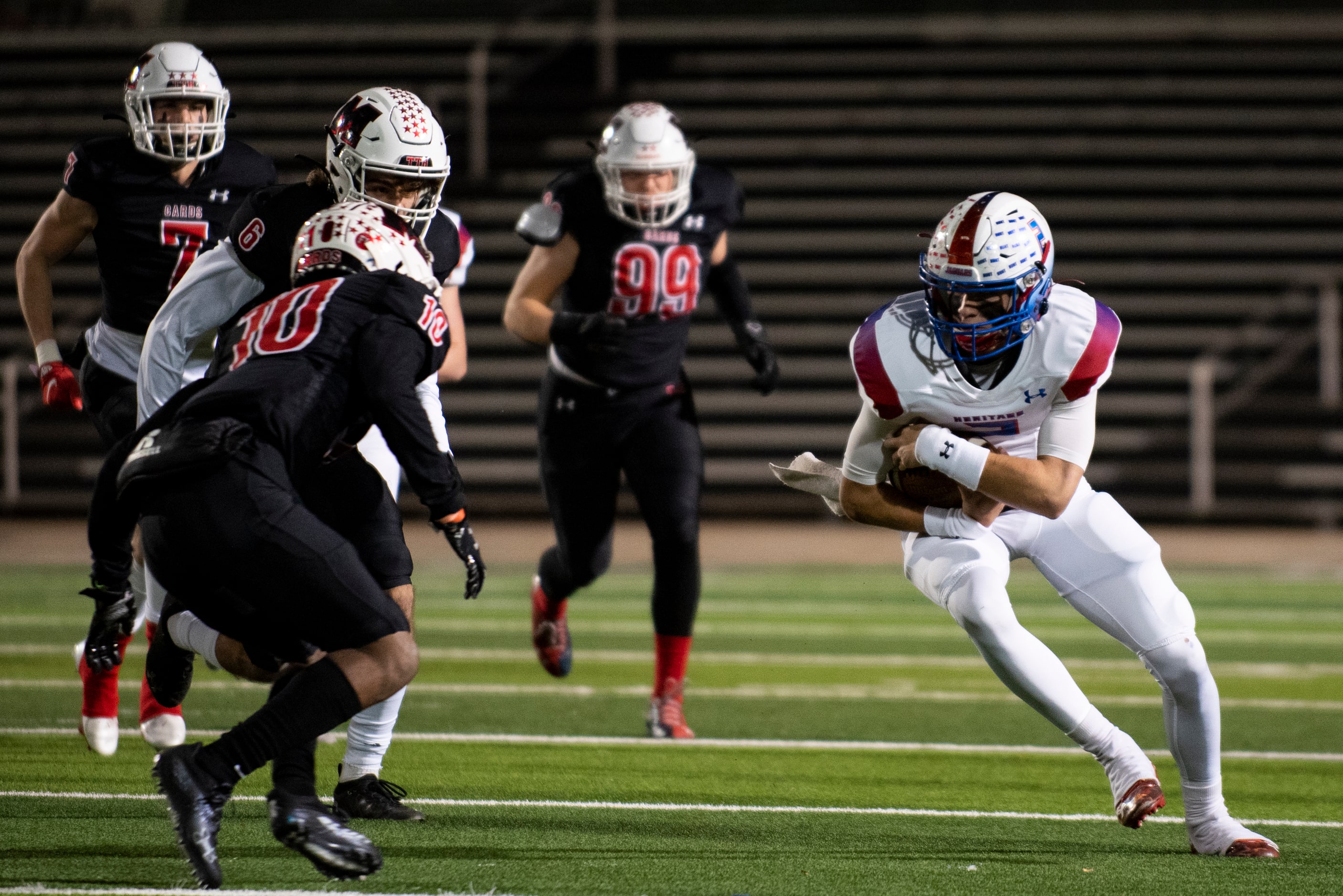 Midlothian Heritage junior Kaden Brown (2) gains yardage before being tackled by Melissa...