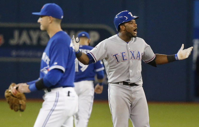 Texas Rangers third baseman Hanser Alberto (68) celebrates at second base after knocking in...