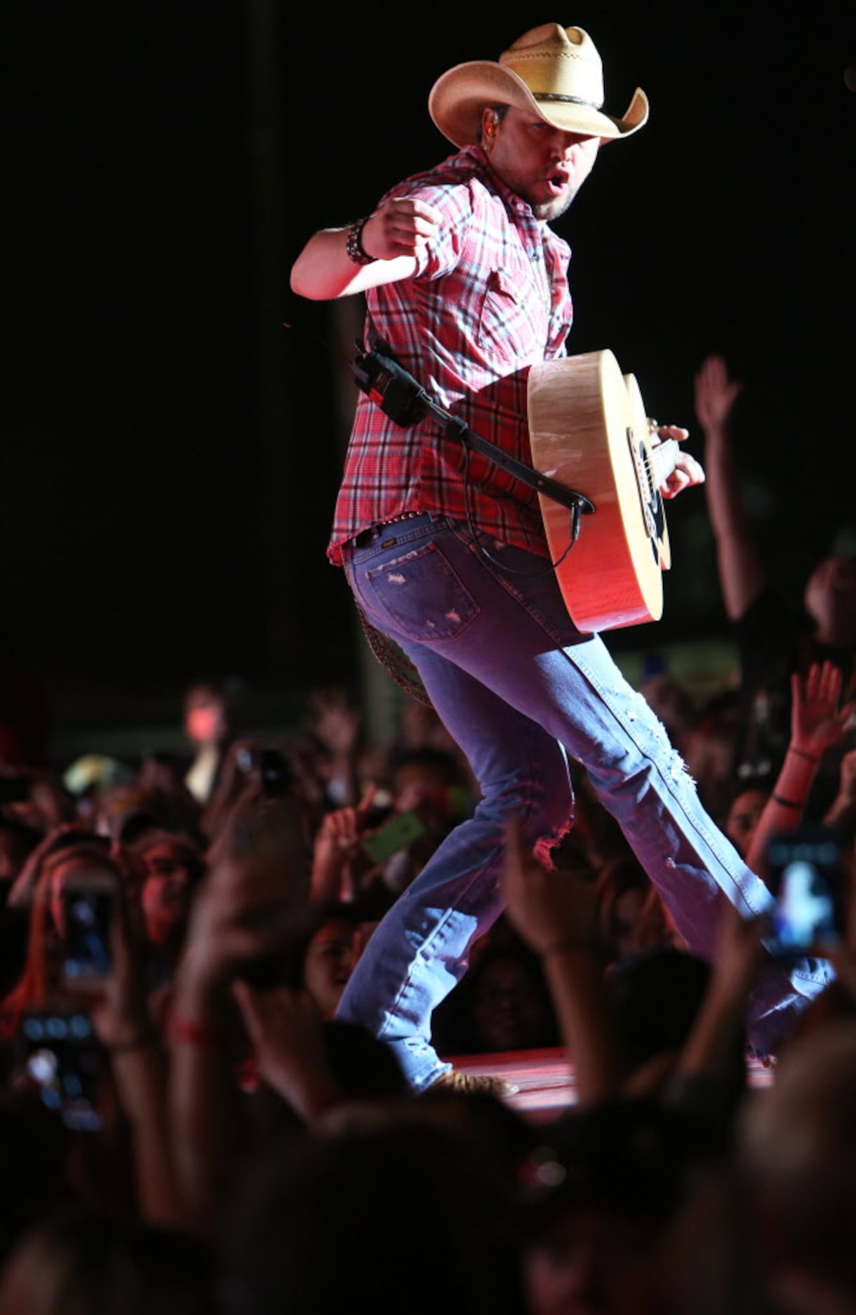 Jason Aldean performs onstage at the 2014 NCAA March Madness Music Festival  during the NCAA...