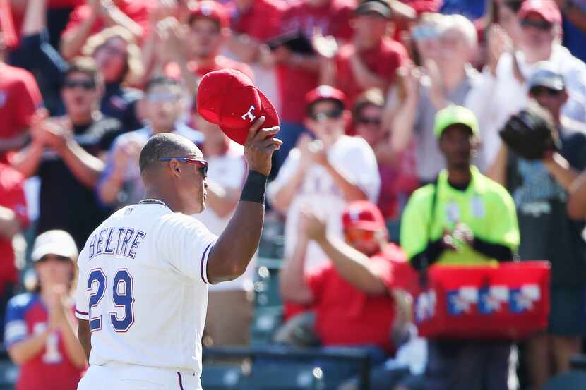 Texas Rangers third baseman Adrian Beltre (29) lifts his hat to the crowd as he leaves the...