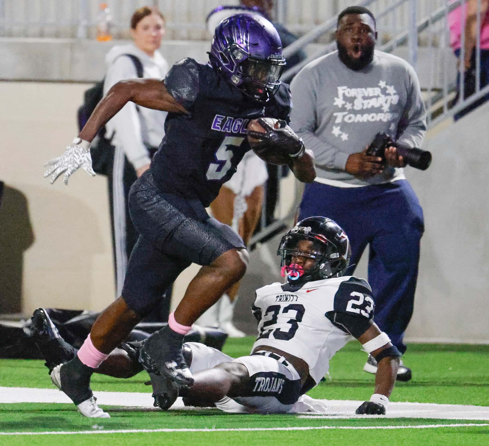 Crowley High’s Caleb Pope (5) runs past Trinity High’s Keondre Dixon during the first half...