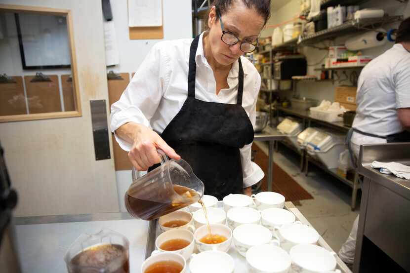 Chef Sharon Hage pours tea in the kitchen at Grange Hall.