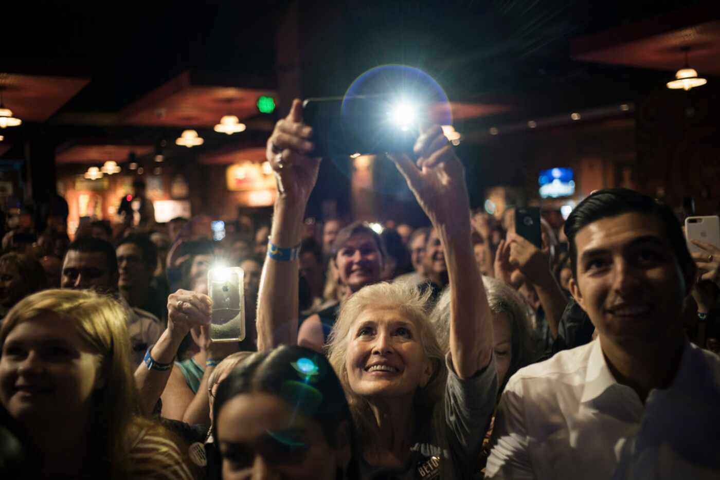 A woman takes a photograph during an event for Rep. Beto O'Rourke (D-Texas), the Democratic...