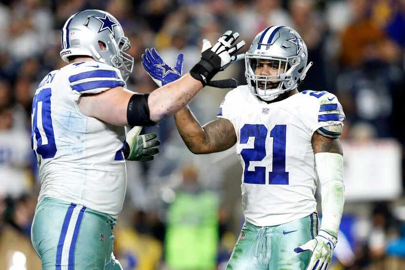 Dallas Cowboys running back Ezekiel Elliott (21) is congratulated by offensive guard Zack...