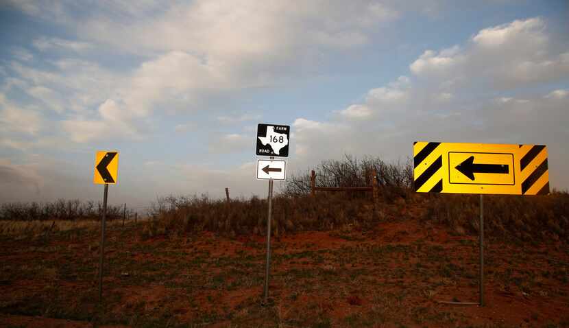 Directional signs point north where FM 168 begins at the junction with FM 1076 in Terry...