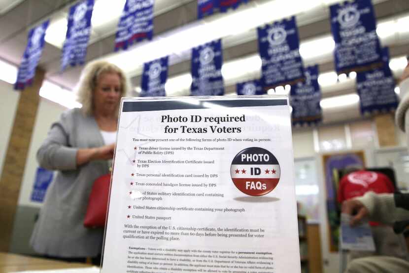 In this March 1, 2016, file photo, a sign tells voters of voter ID requirements before...