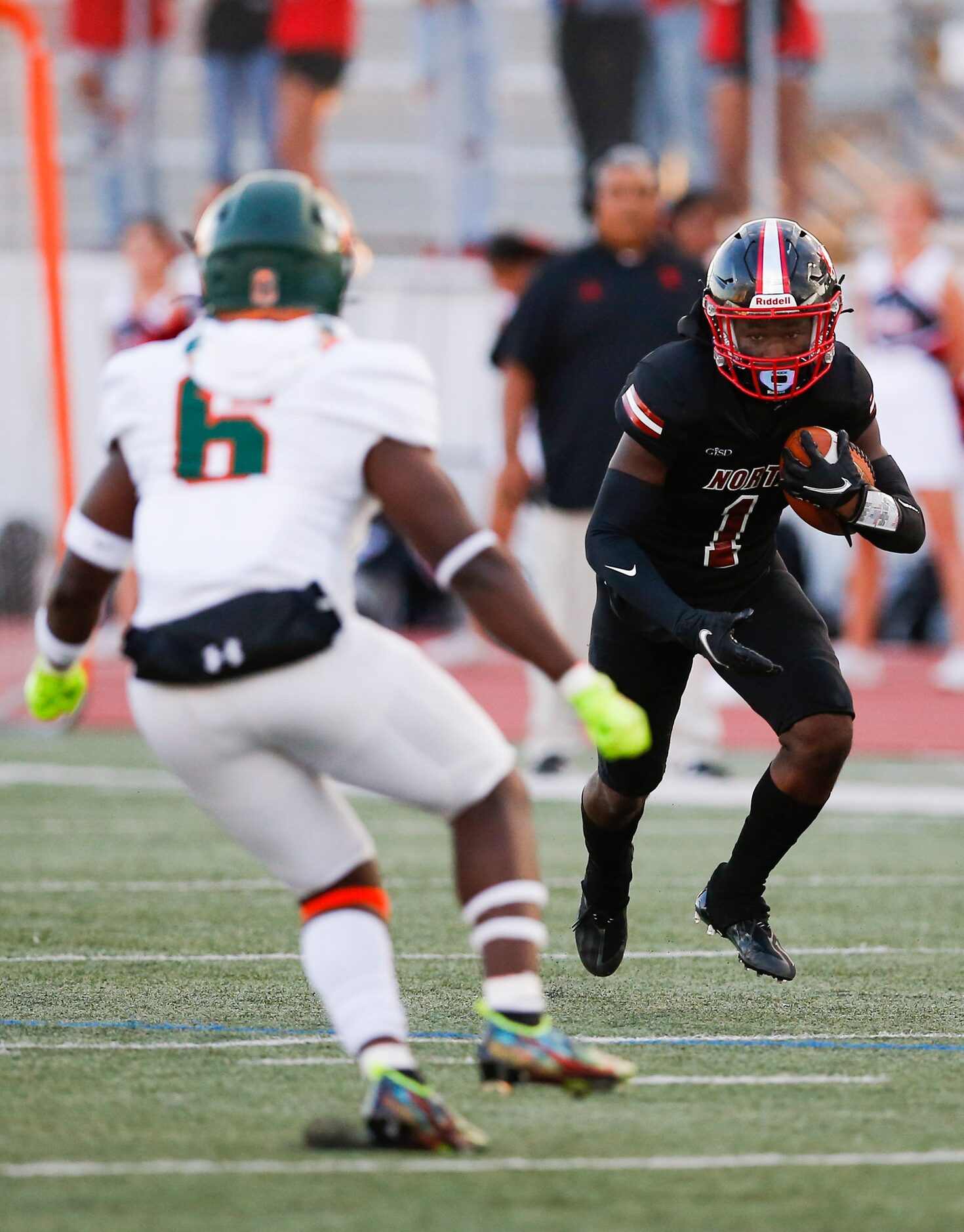 North Garland sophomore wide receiver Mateo Howard (1) looks for room against Garland Naaman...