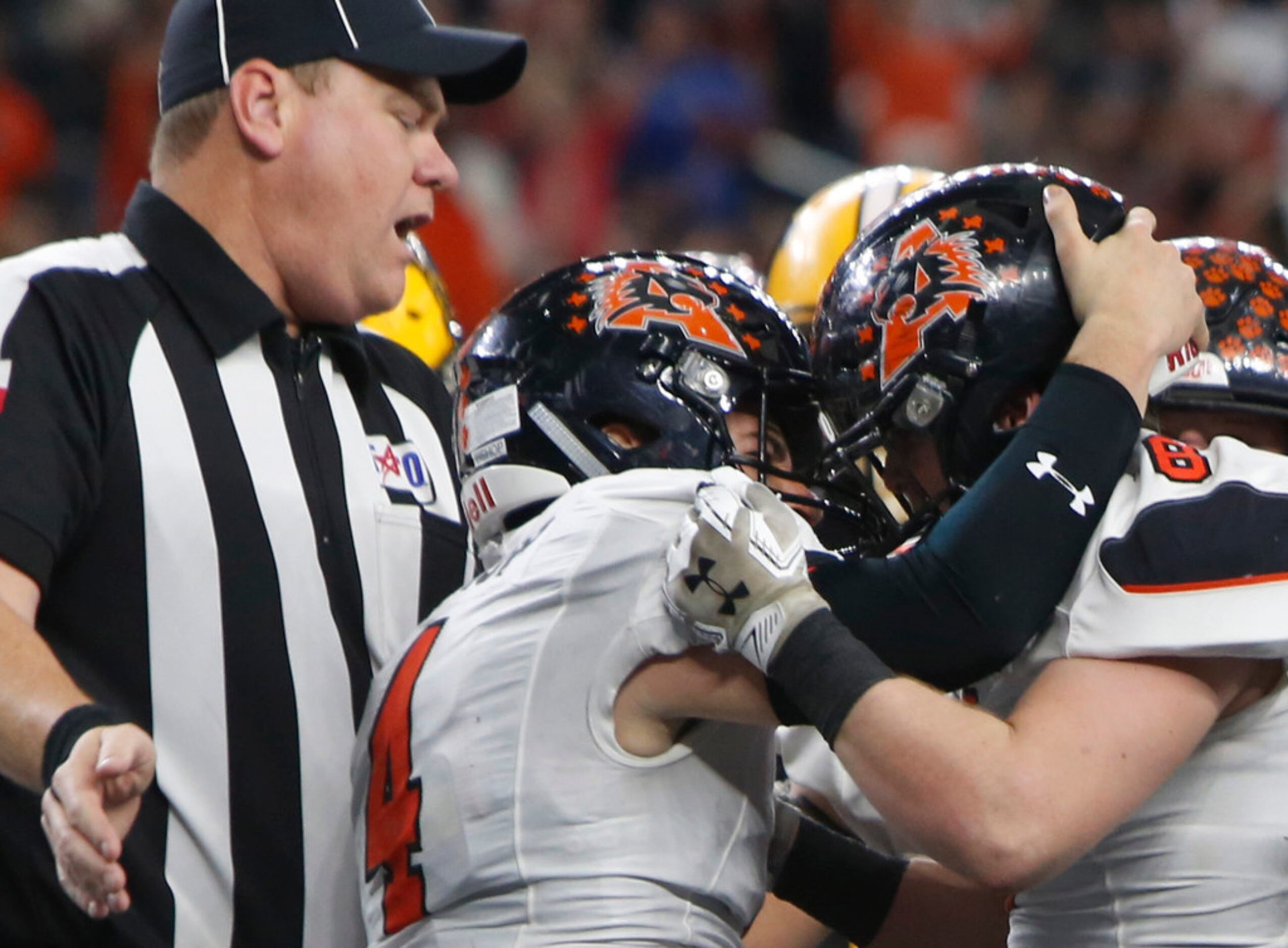 A game official is quick to move in and stop a spontaneous celebration between Aledo...