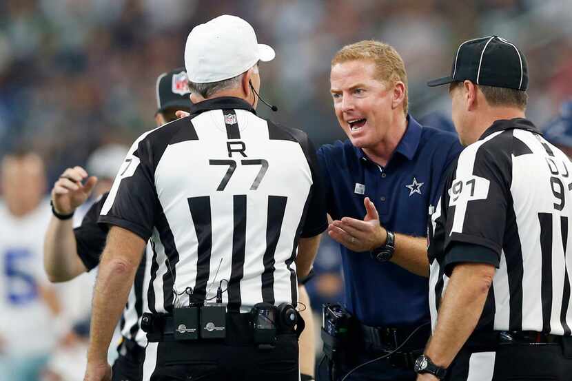 Dallas Cowboys head coach Jason Garrett talks to referee Terry McAulay (77) after a penalty...