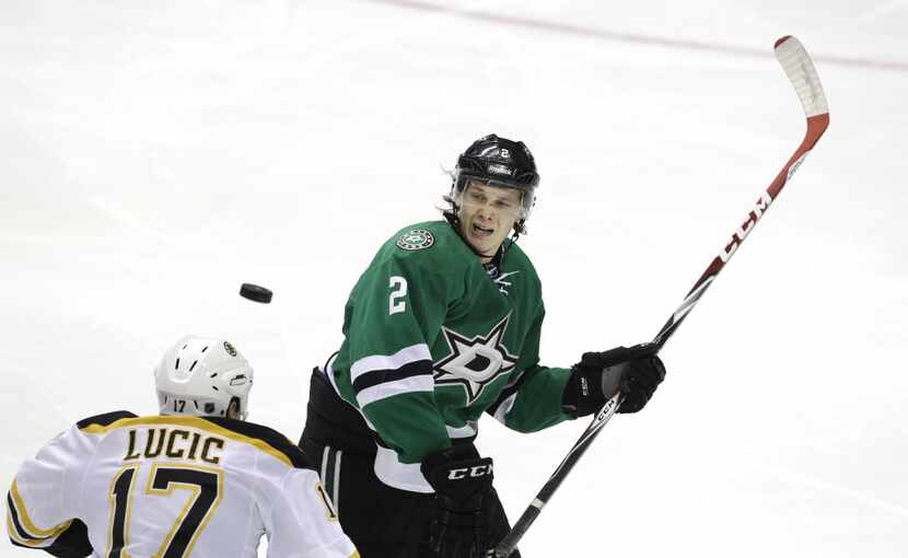 Dallas Stars defenseman Jyrki Jokipakka (2) and Boston Bruins left wing Milan Lucic (17)...