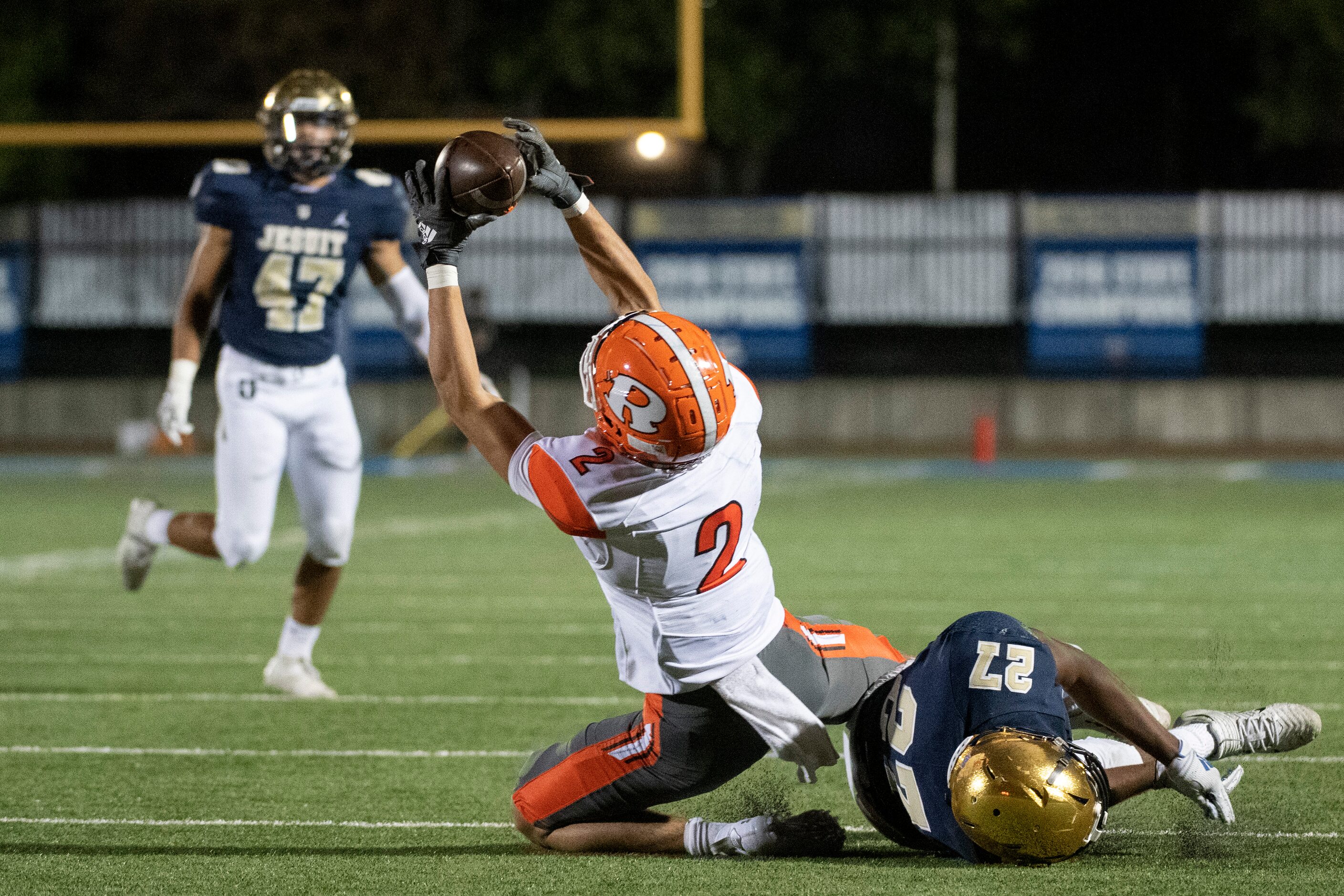 Rockwall senior wide receiver Brenden Bayes (2) makes the catch over Jesuit senior defensive...