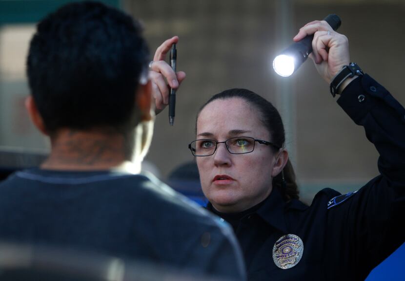 DWI police officer Stacie Brown does a Horizontal Gaze Nystagmus test on a man arrest for a...