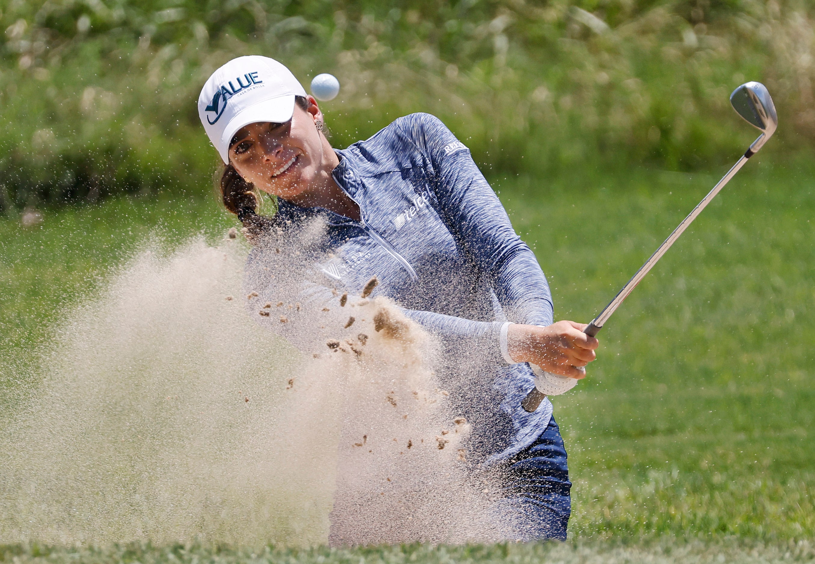 Professional golfer Gaby Lopez fires a shot out of the No. 9 green side bunker during the...