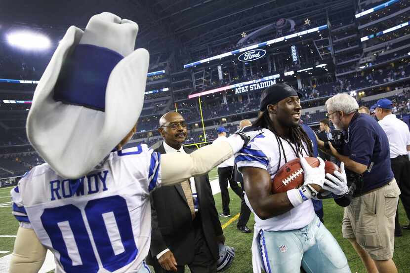 Dallas Cowboys wide receiver Dwayne Harris (17) carries a pair of game balls to the locker...