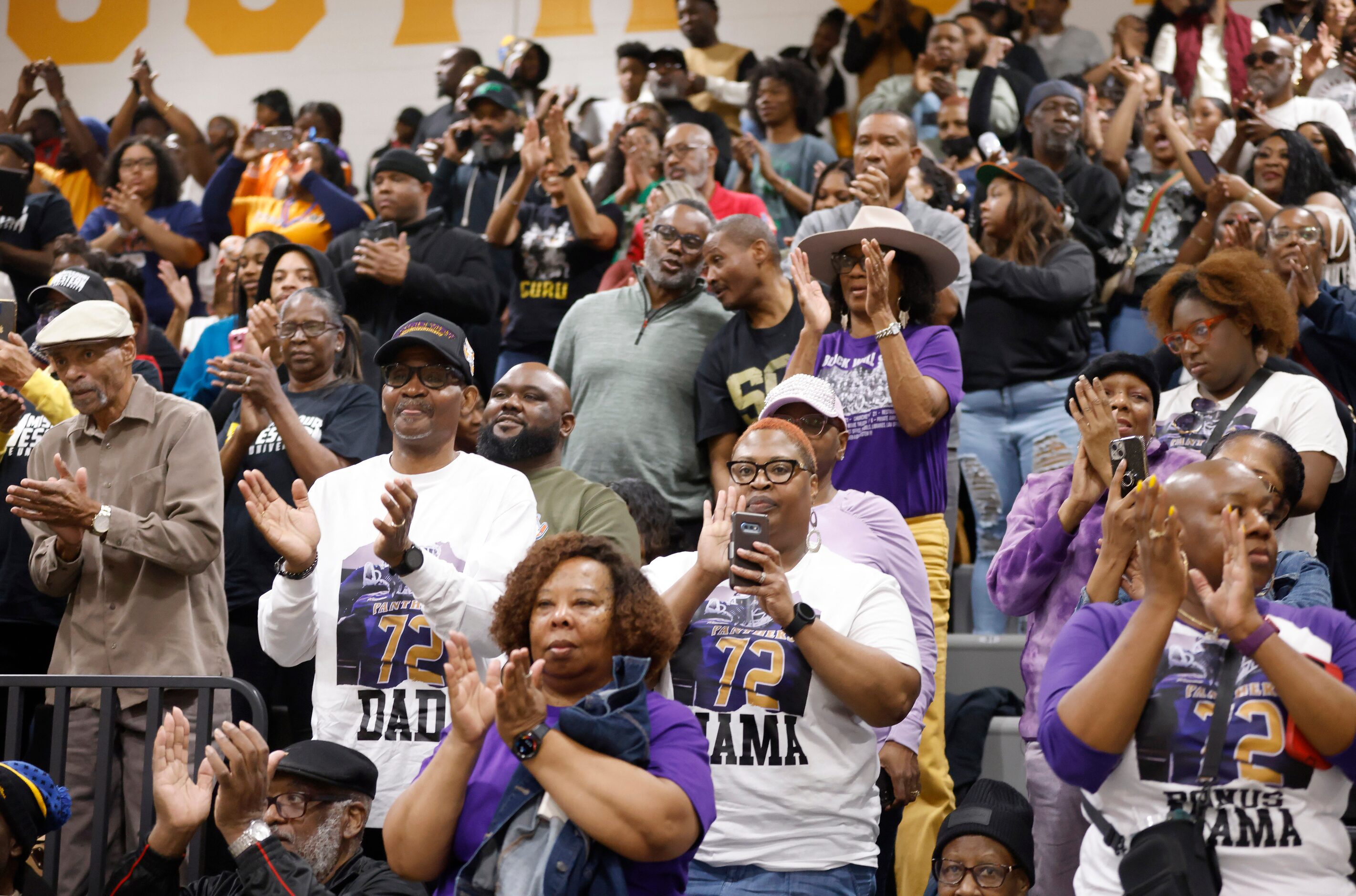 South Oak Cliff football player parents applaud the players during the national letter of...