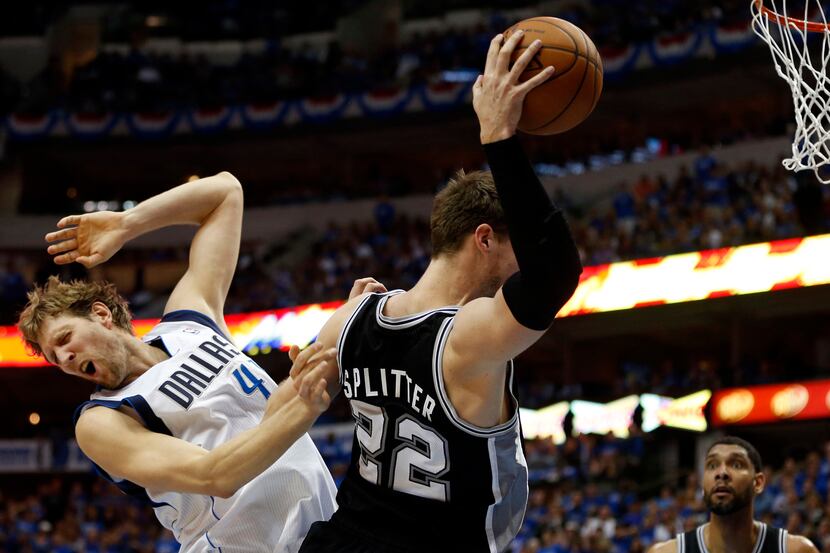 San Antonio Spurs center Tiago Splitter (22) grabs a rebound in front of Dallas Mavericks...