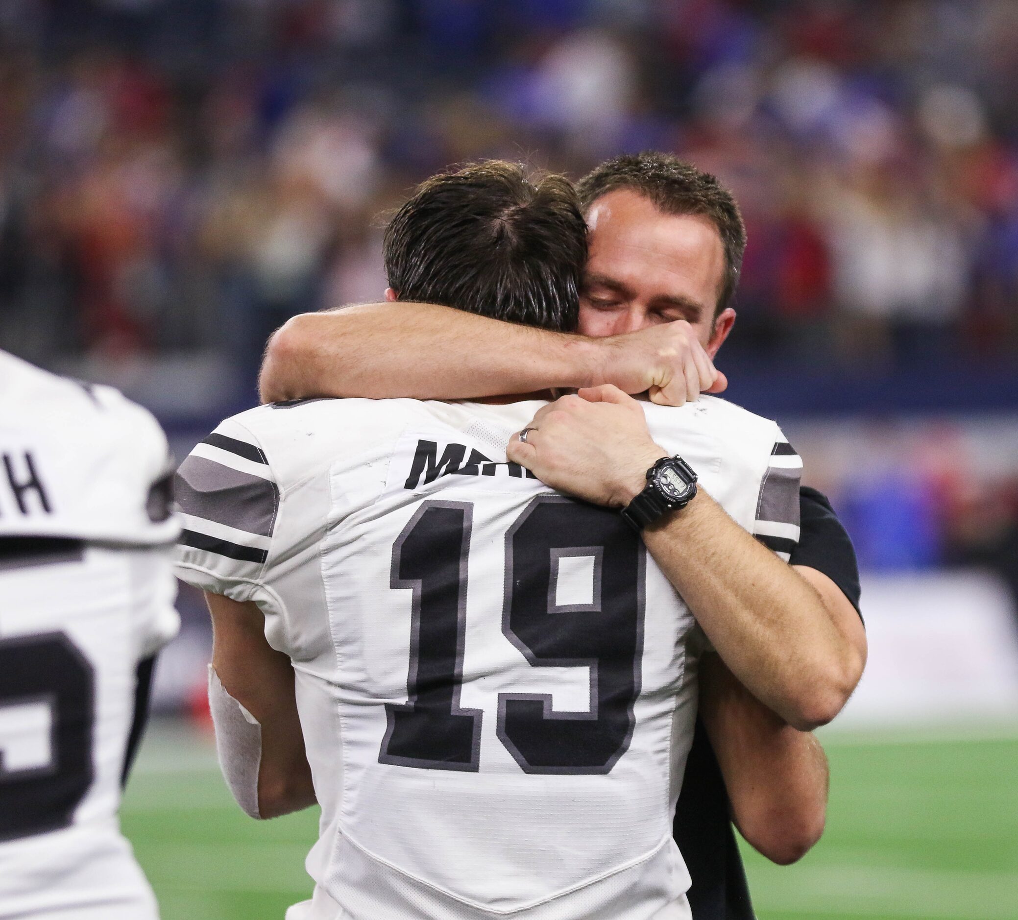 A Denton Guyer coach hugs player Seth Meador (19) in the fourth quarter of a Class 6A...