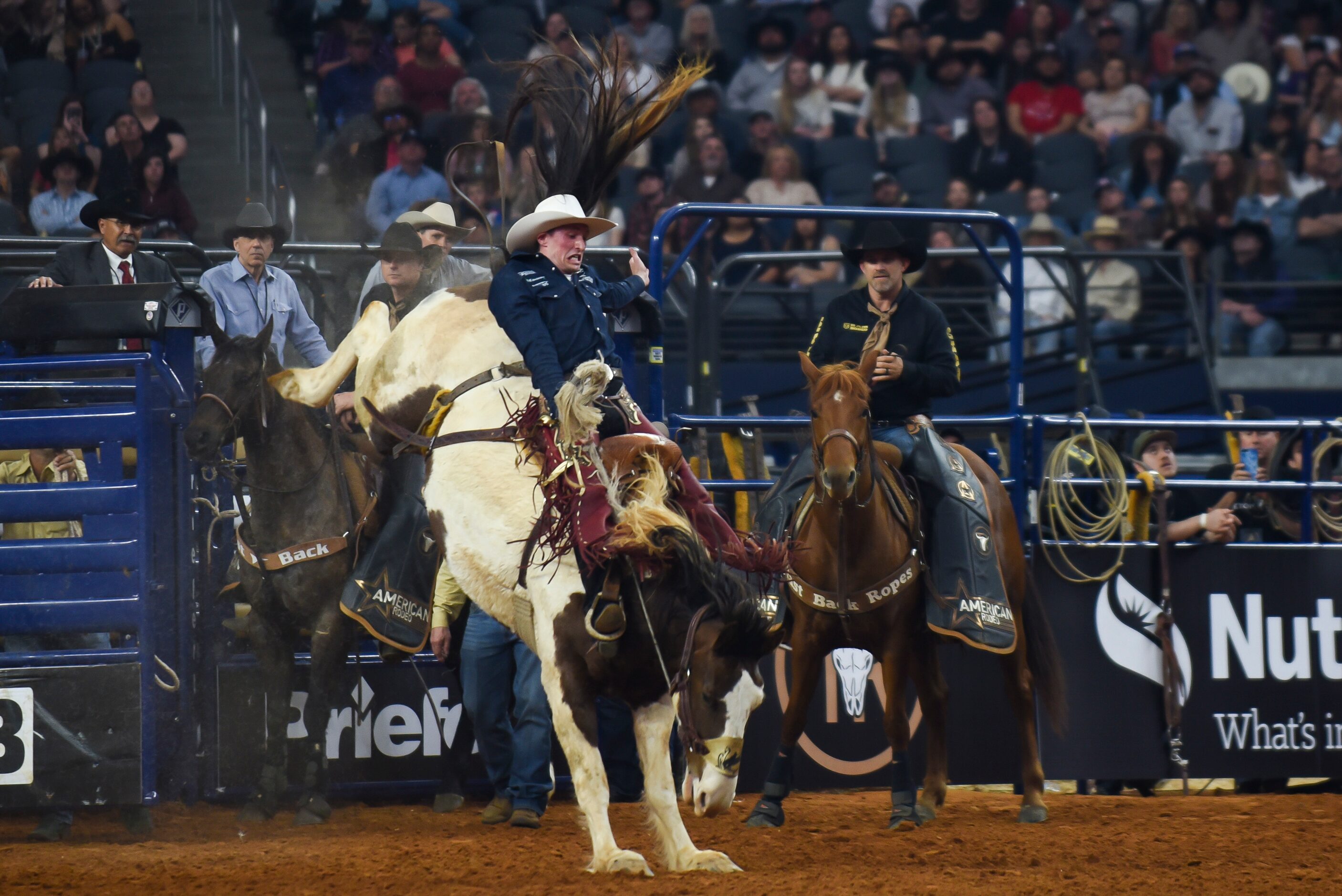 Chase Brooks attempts to stay on his horse during the Saddle Bronc event during the...