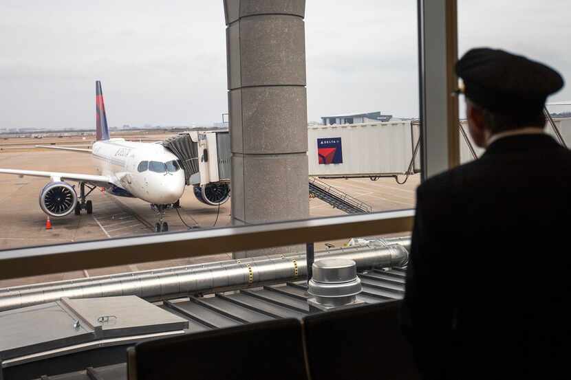 Delta's new Airbus A220-100 airplane attracts attention while parked at gate E15 of Terminal...