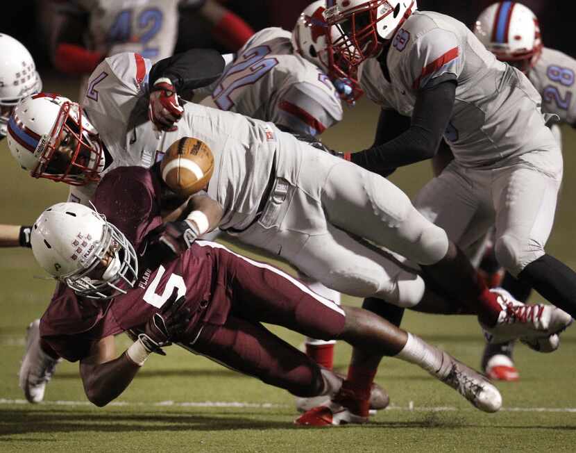 Skyline Raiders linebacker Anthony Wheeler (7) causes a fumble from Plano Wildcats running...