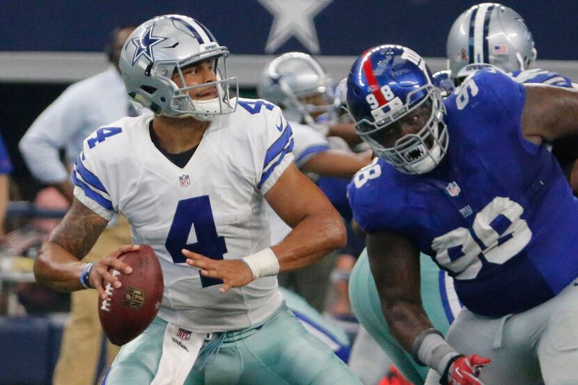 Dallas Cowboys quarterback Dak Prescott (4) throws under pressure by New York Giants...
