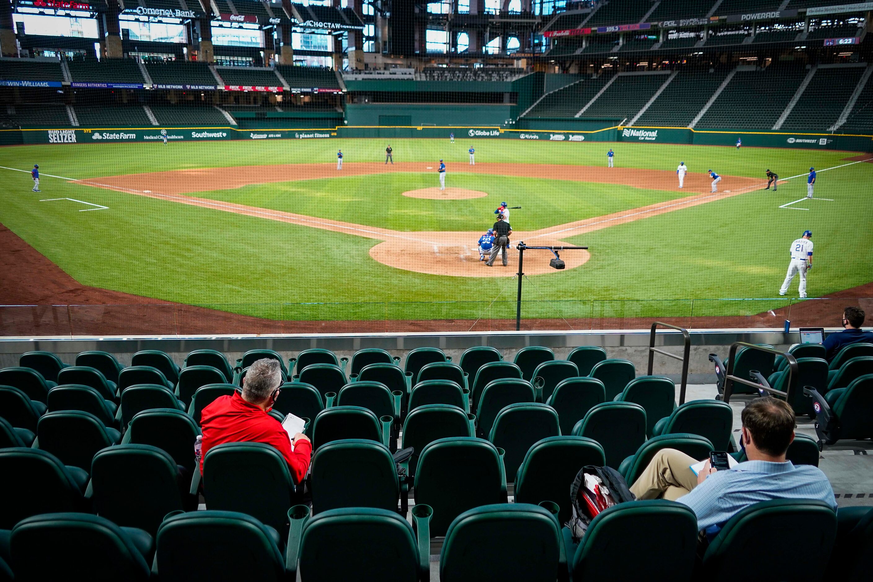 Scouts, including Senior Director of Amateur Scouting Kip Fagg (left) watch an intrasquad...