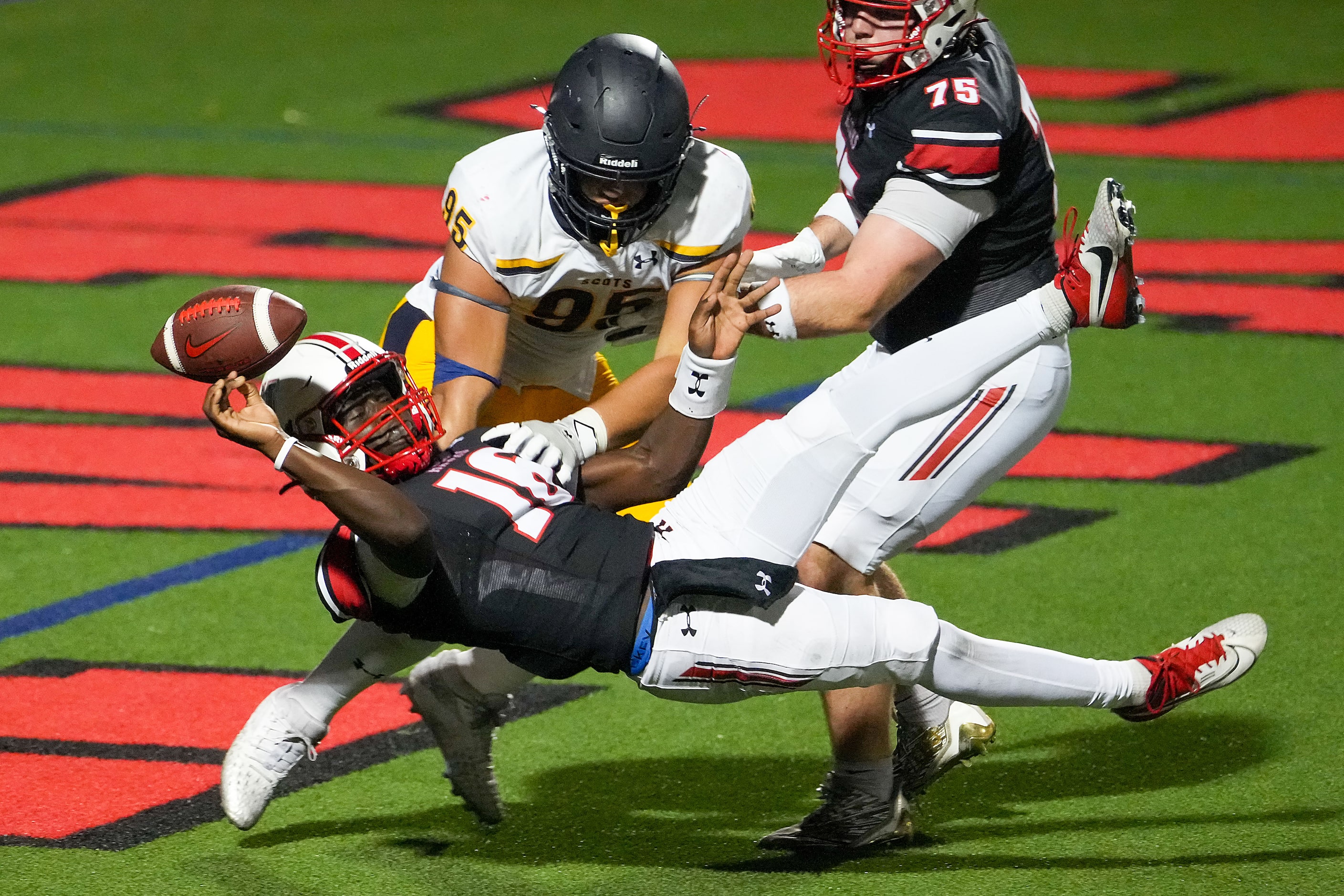 Rockwall-Heath quarterback Prosper Neal (16) barely gets off a pass as he is dropped in the...