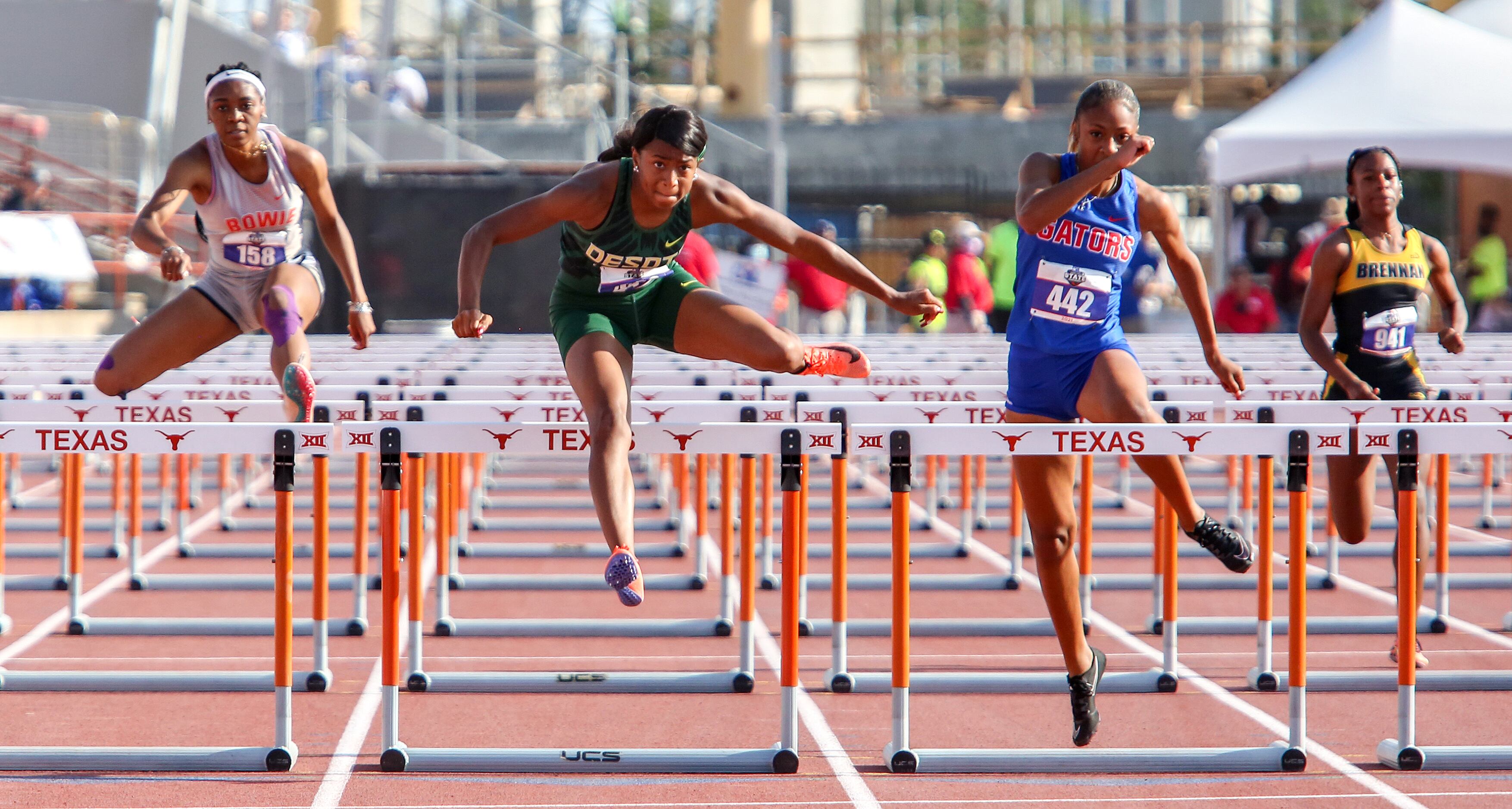 DeSoto's Jalaysi'ya Smith jumps over the last hurdle in the 6A Girls 100 meter hurdles...