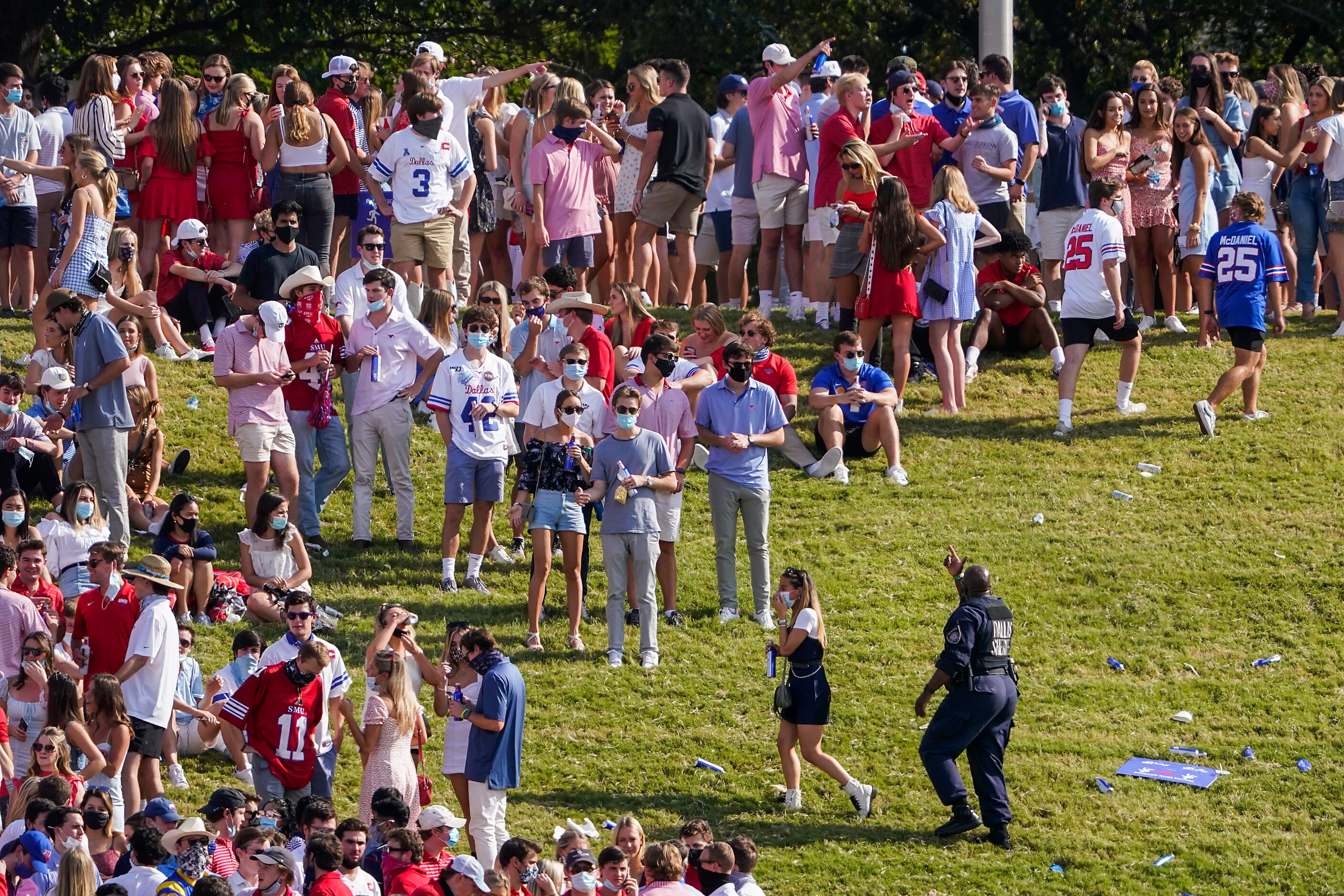 Law enforcement clears SMU students from the hill in the south end zone during the first...